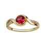 Gold ring with a red gemstone and diamond accents on a white background