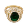Gold ring with a green gemstone and diamond accents on a white background