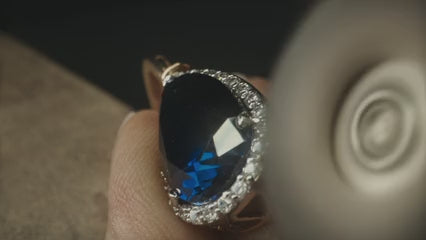 Close-up video of a jeweler carefully polishing a piece of jewelry.