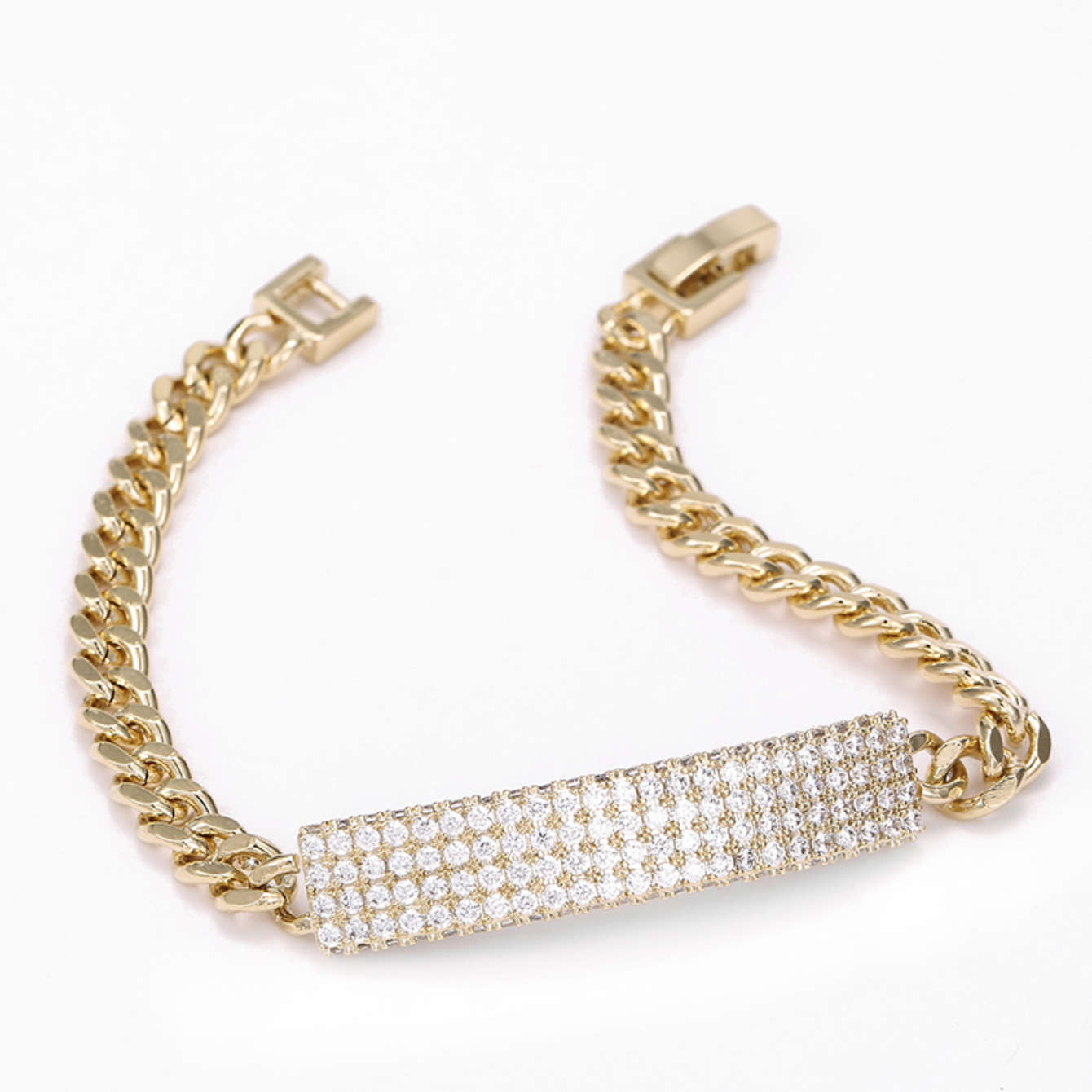 Gold chain bracelet with a diamond-studded bar on a white background